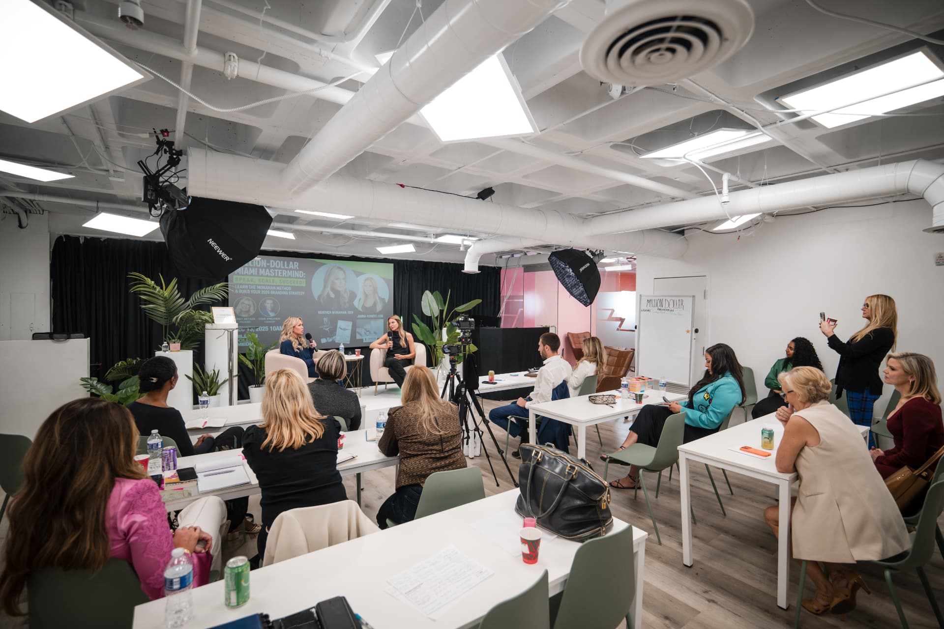 Wide view of the Miami Mastermind room during a fireside conversation